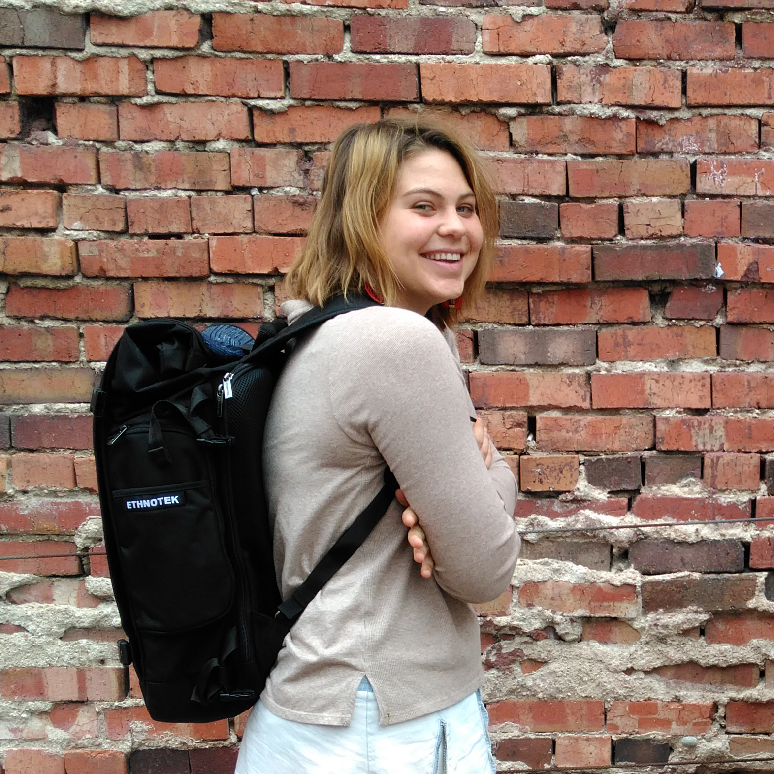 Photo of Gabby Vermeire with a donated Ethnotek backpack